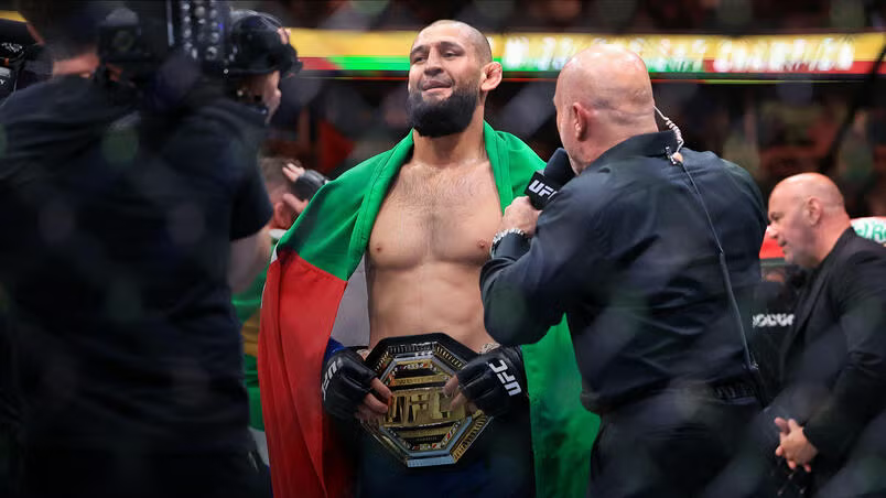 Khamzat Chimaev hoists the UFC middleweight belt inside Chicago’s United Center after dominating Dricus du Plessis.